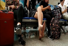 Lady dangling shoeplay when waiting for a train 21
