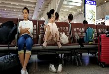 Lady remove shoe and relax her tired feet on the chair when waiting for a train 23
