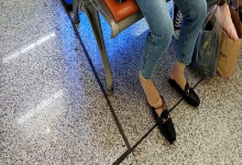 Lady remove shoe and relax her tired feet on the chair when waiting for a train 25