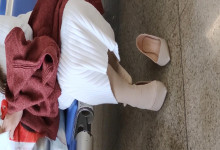 Lady dangling shoeplay when waiting for a train 50