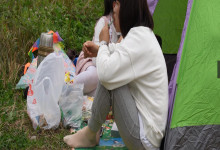 The lady remove shoes relax her tired nylon feet on the grass