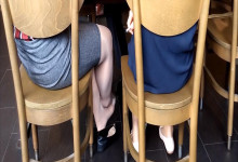 2x ladys sit down dipping and shoeplay under the table at same time