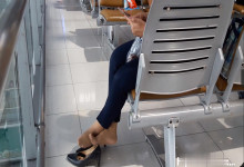 The lady remove heels relax her feet when line up in the airport waiting hall 4