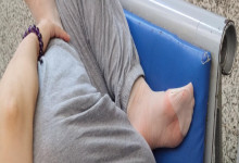 The lady remove shoes relax her tired feet when waitting for a train 53