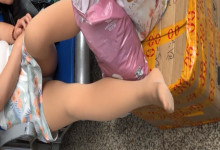 The lady remove shoes relax her tired feet when waitting for a train 56