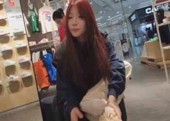 Beautiful girl trying on new shoes in shoe store