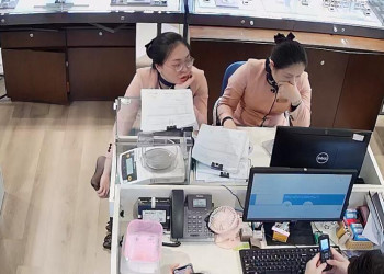 The jewelry store hostess in black nylon footmassage by herself