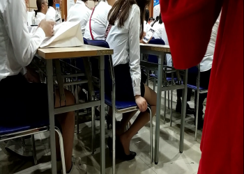 The girl takes off her shoes under the desk when have a meeting