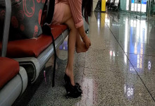 Lady dangling shoeplay when waiting for a train 48