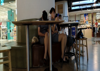 The lady in white nylon dangling shoeplay when having lunch