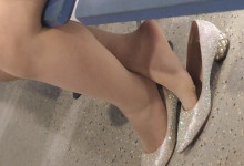 The lady dangling shoeplay in the lounge