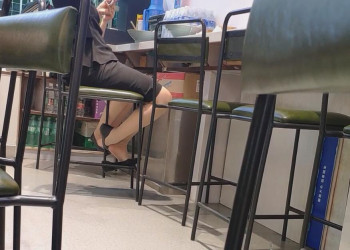 The girls like dangling shoeplay under the table when having lunch