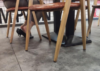 The beautiful girl shoeplay while eating