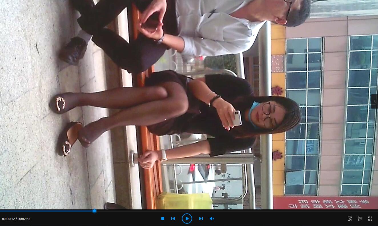 Pretty girl in black nylon dangling shoeplay when playing cell-phone