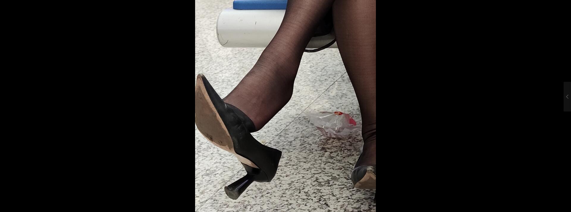 Lady dangling shoeplay when waiting for a train 36