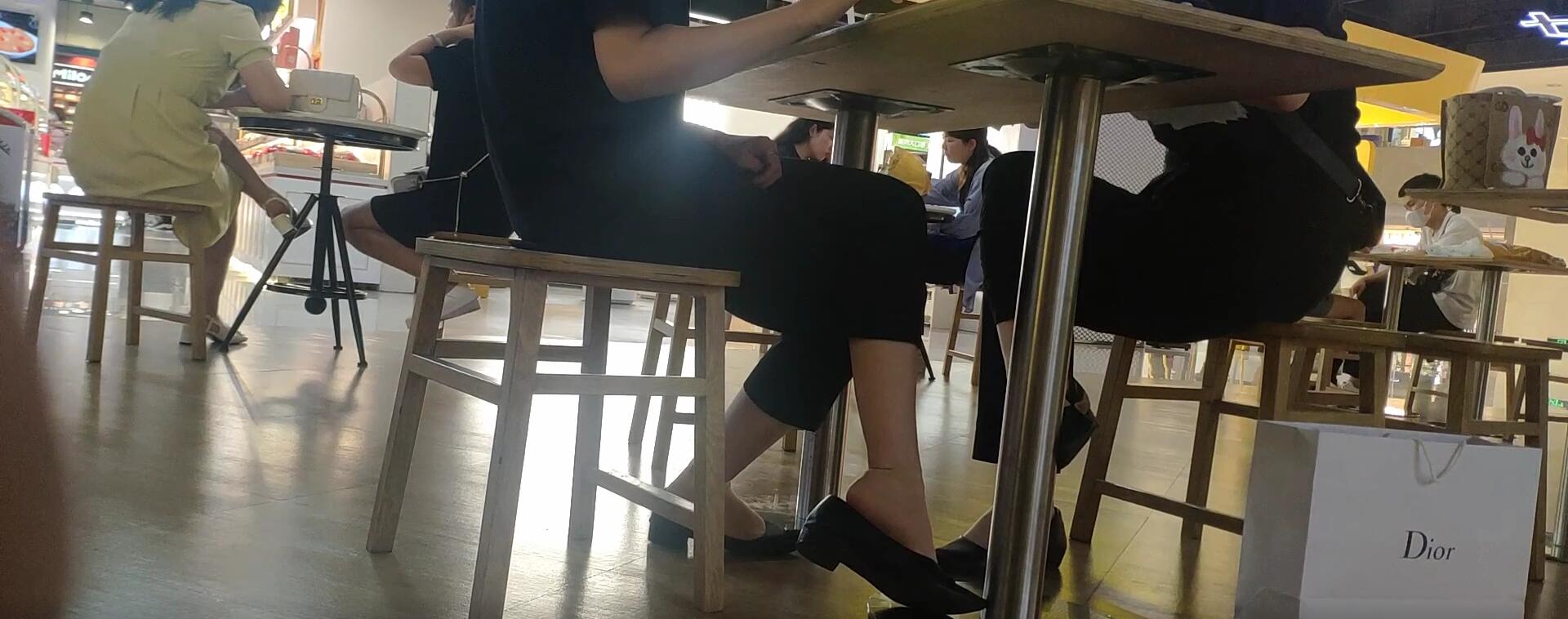 The girls dangling shoeplay under the table when having lunch 6