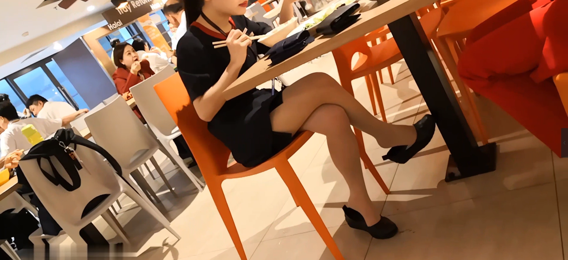 The girl dangling shoeplay under the table when having lunch 26