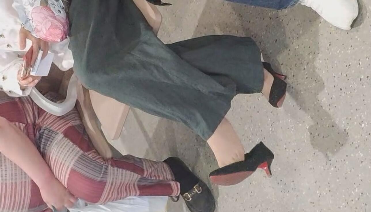 Many of girls dangling shoeplay in the train station lounge