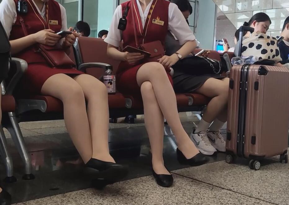 The flight attendants sat down and took off their high heels to relax their feet