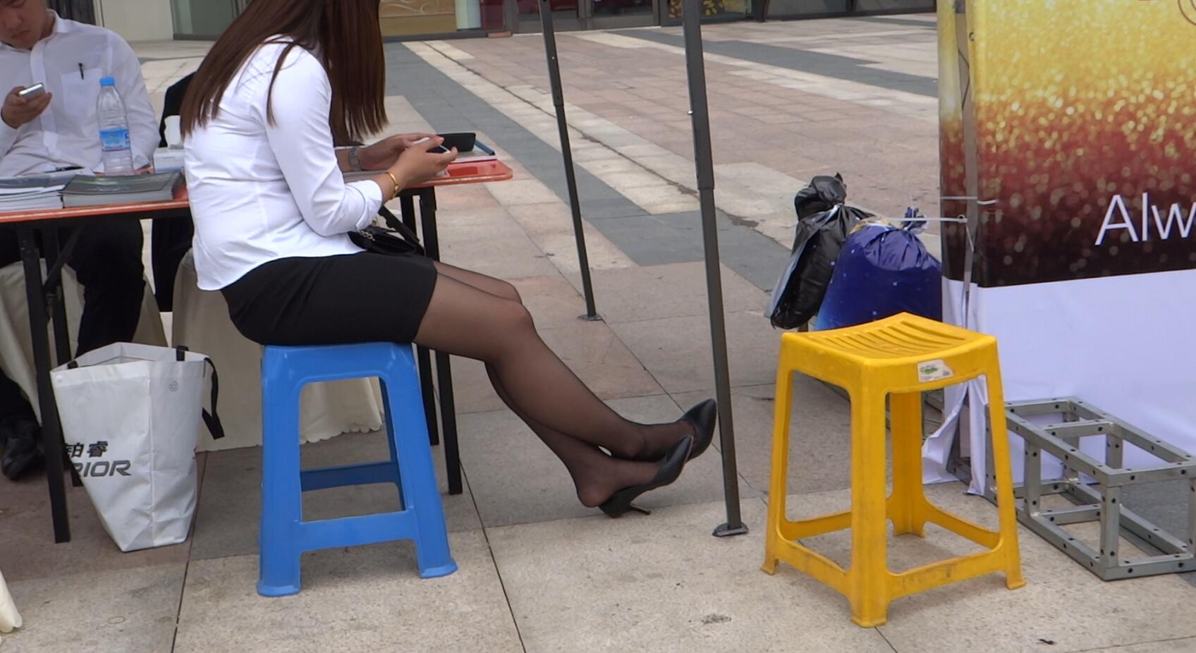 Sales girl in black nylon have a rest heelpopping and shoeplay