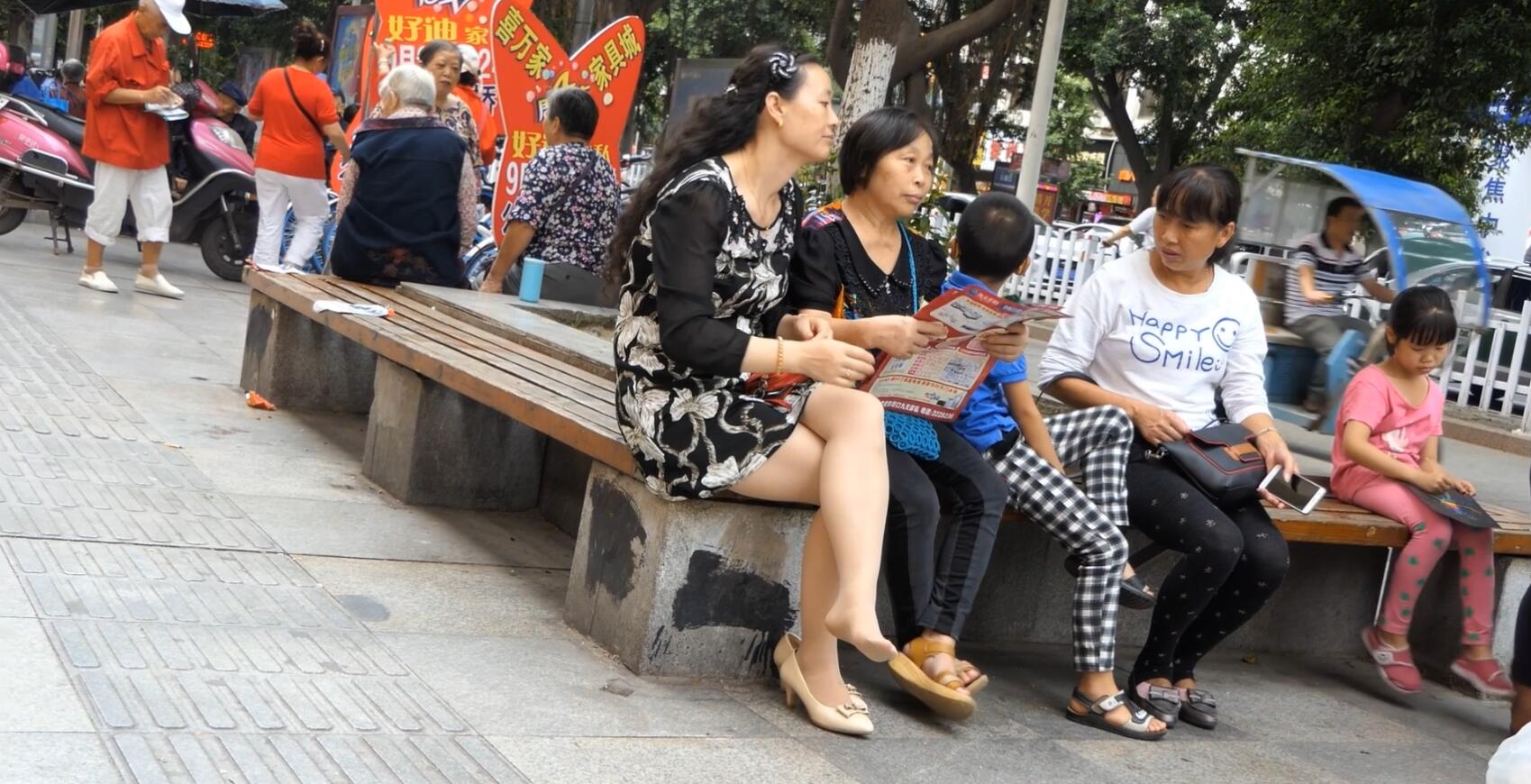 Long hair lady in white heels shoeplay on the rest bench