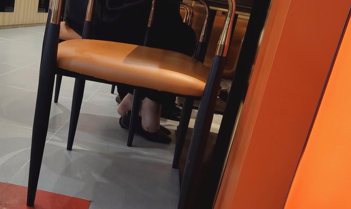 The hostess in black nylon great dangling shoeplay under the table when having lunch 3