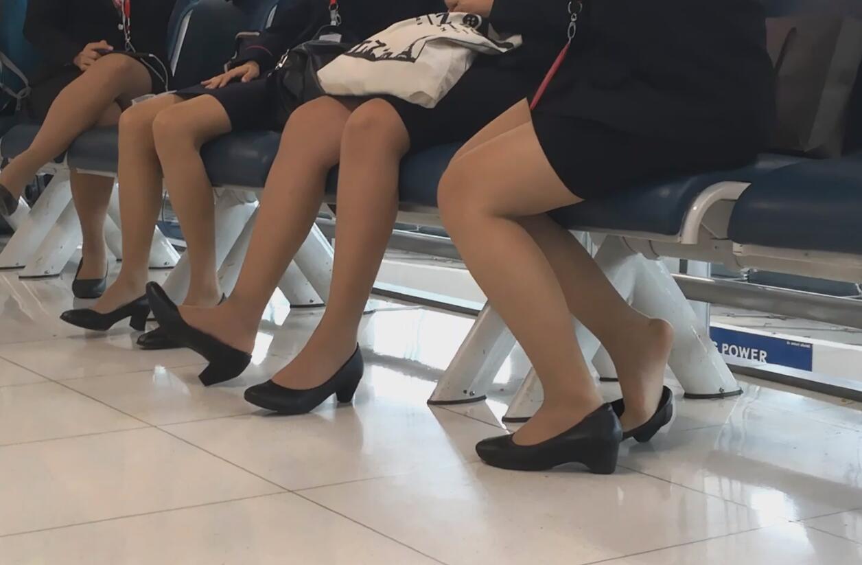 A group of air hostess are waiting for the plane